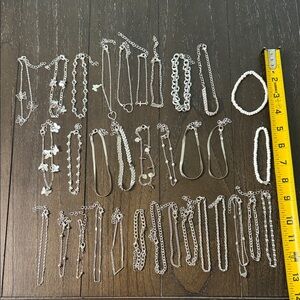 Random assortment of 33 silver and white bracelets
